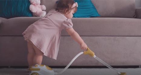 Girl vacuuming carpet